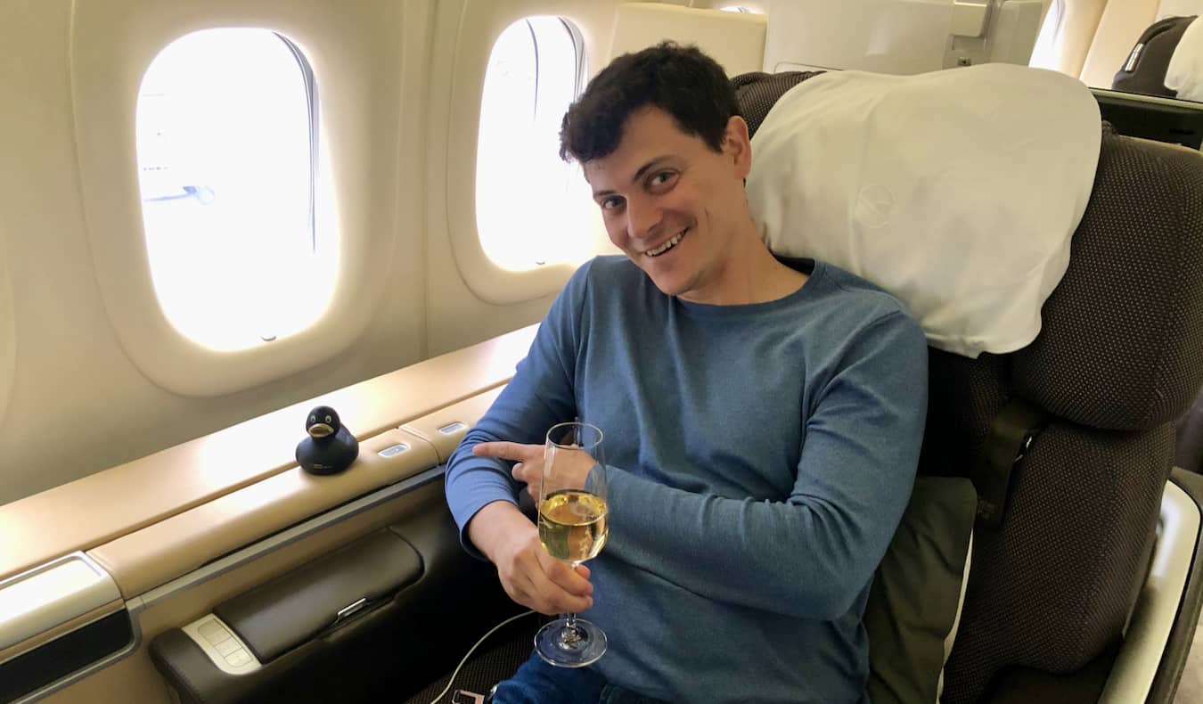 Nomadic Matt enjoying a first class seat while flying around the world